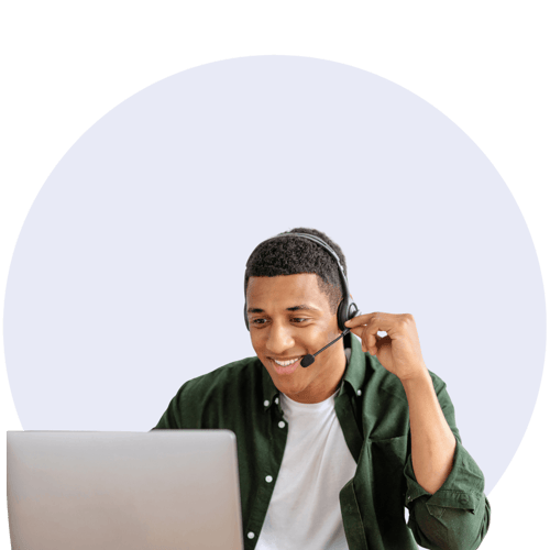 male with headset looking at laptop