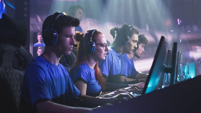 image show a line of students playing in a esports competition