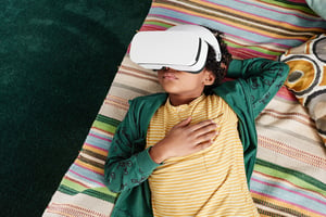 image shows Generation Alpha boy with a VR headset on