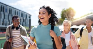 Image shows a female student holding paper and notepad