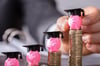 image shows piggy banks with student graduation hats on them 