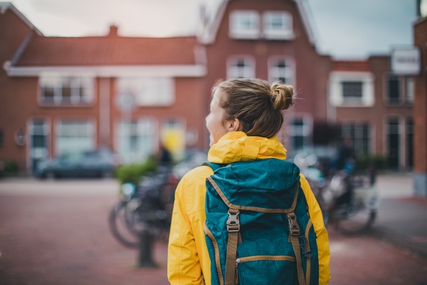 Girl walking outside with back pack 