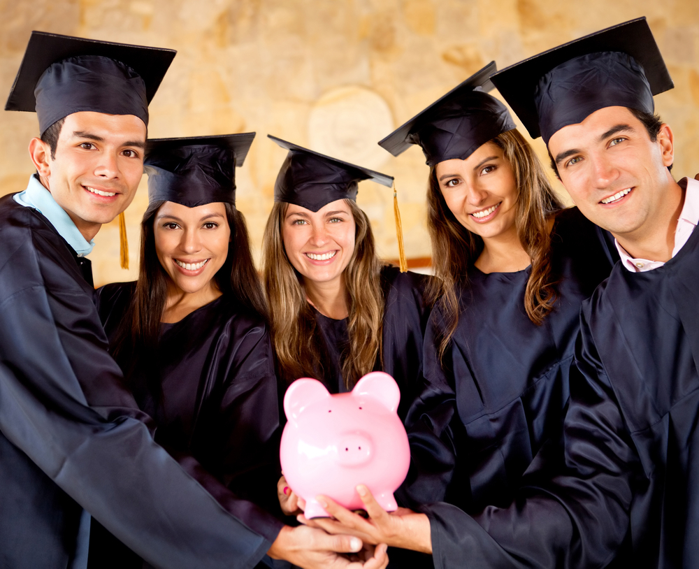 Graduate students holding a piggybank with education savings