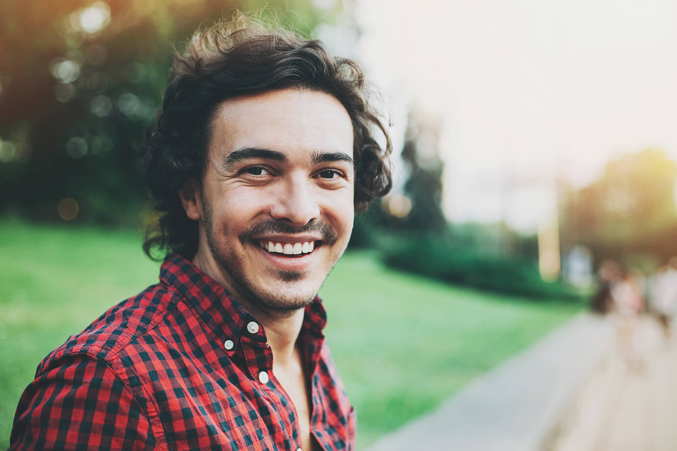 Man in checked shirt smiling