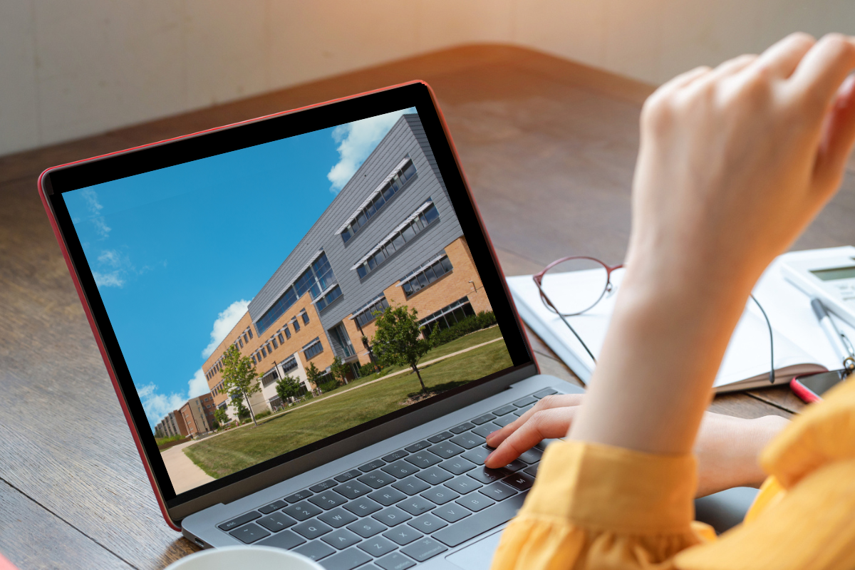 someone on their laptop with a virtual campus tour on their screen