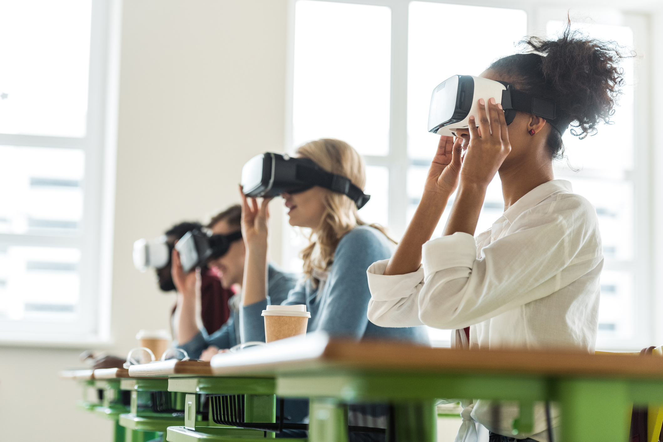 Students sitting in a row using a virtual reality headset 