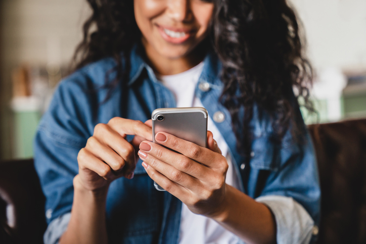 picture shows a woman using her mobile phone