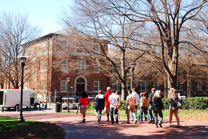 Picture shows a group of students walking around a university campus